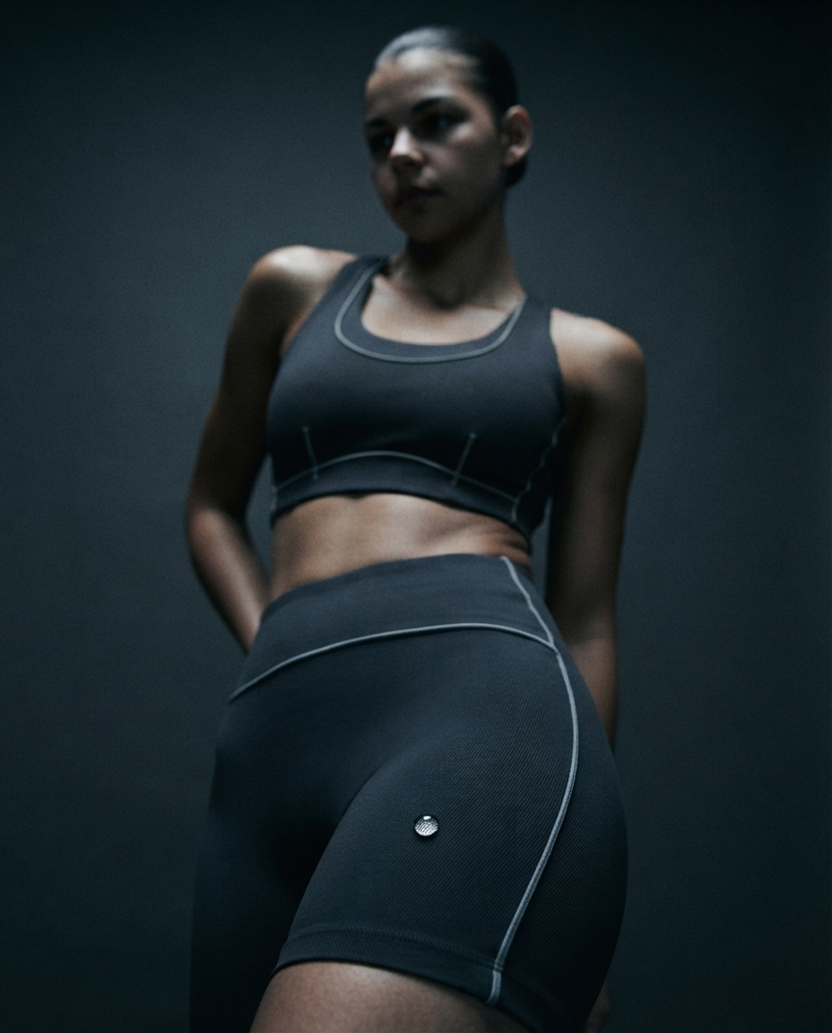Compression running apparel shot on a charcoal seamless backdrop under hard raking light